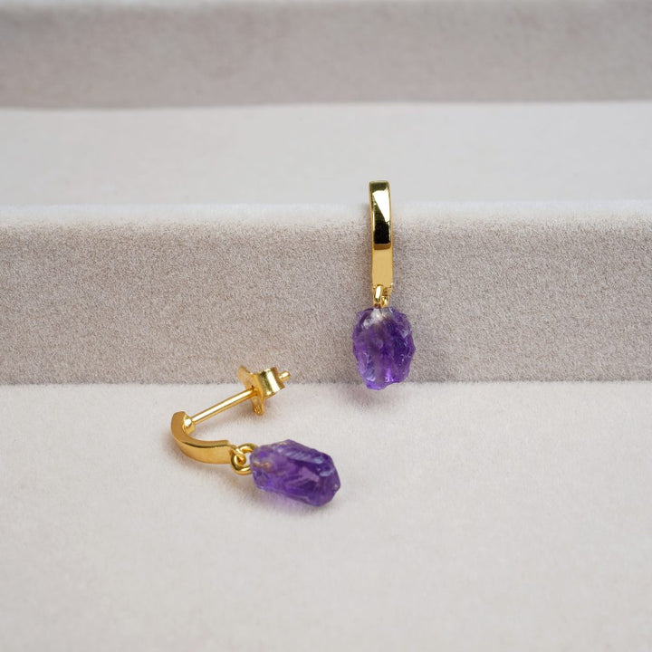 Gold earrings with beautiful purple gemstone Amethyst. Earrings in gold with popular crystal Amethyst.