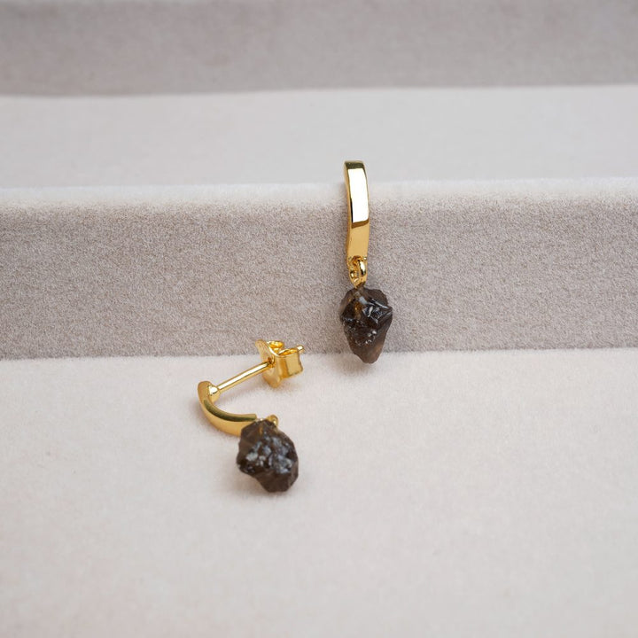 Beautiful gold earrings with small Smoky quartz crystals in raw form. Earrings with small raw Smoky quartz stones in a modern design.