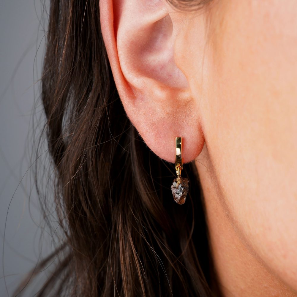 Smoky quartz earrings in gold. Modern gold earrings with small raw brown crystal.