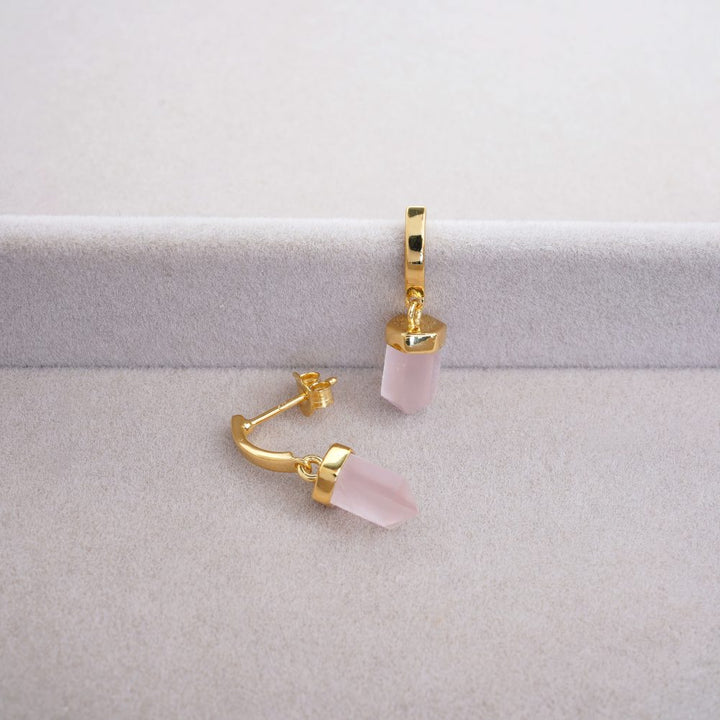 Earrings with Rose quartz crystal in the shape of a point. Modern gold earrings with pink crystal Rose quartz that symbolizes love.