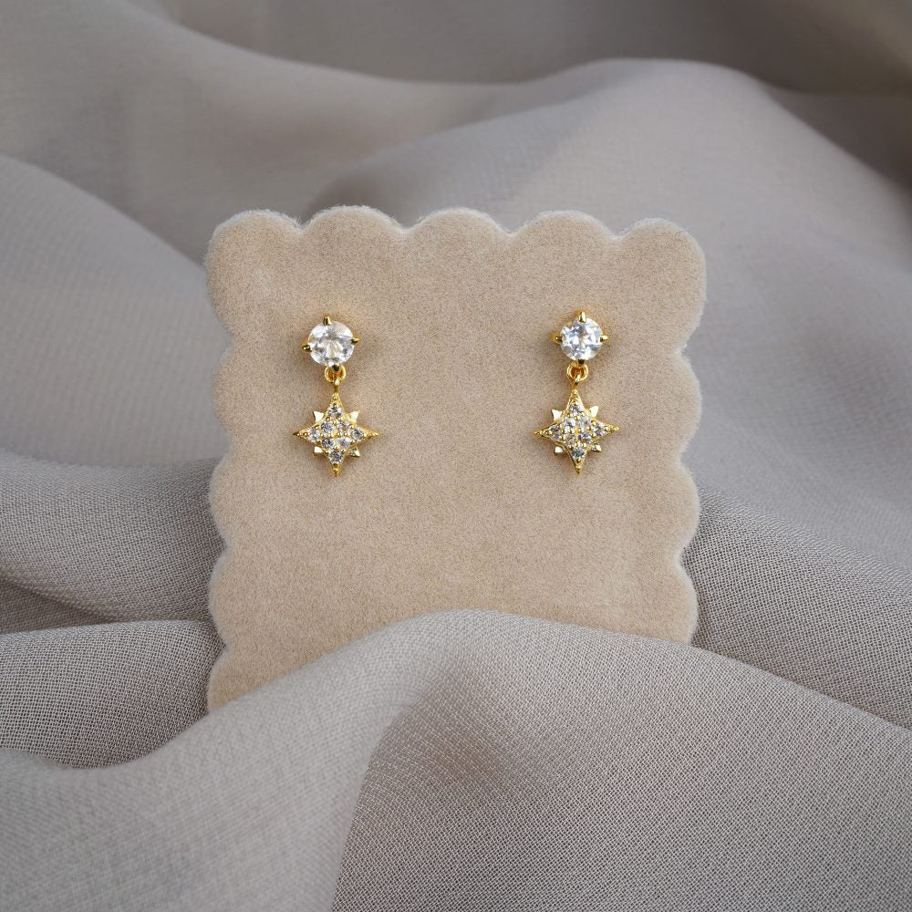 Earrings in gold with sparkling crystals and a beautiful star. Crystal earrings with star and White Topaz gemstones.