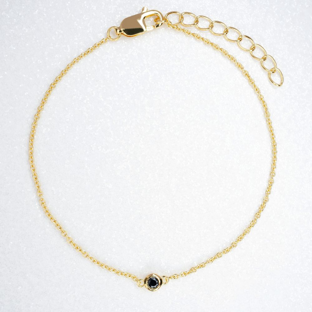Gold bracelet with black crystal Onyx which is July's birthstone. Bracelet with Onyx which stands for confidence, protection and success.