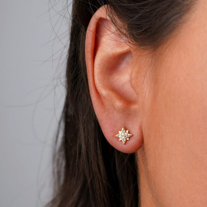 Gold earrings with star and White Topaz crystals. Stud earrings in gold with star of sparkling White Topaz gemstones.