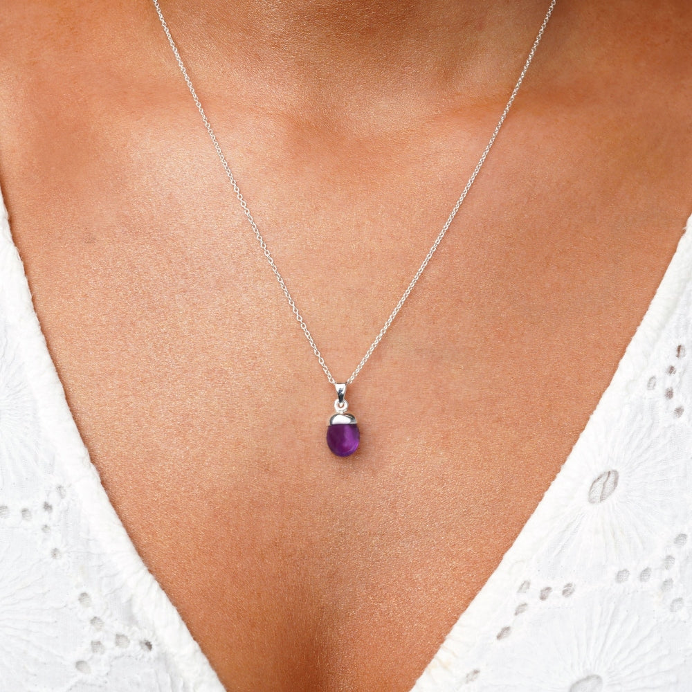 Silver necklace with purple Amethyst in a modern design. Beautiful charm with Amethyst that shines a beautiful light purple color against the skin.