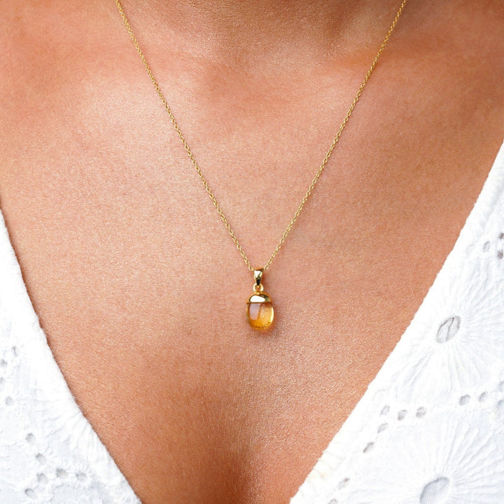 Necklace with tumbled small Citrine charm in gold. Jewelry with yellow Citrine which stands for happiness and manifestation.