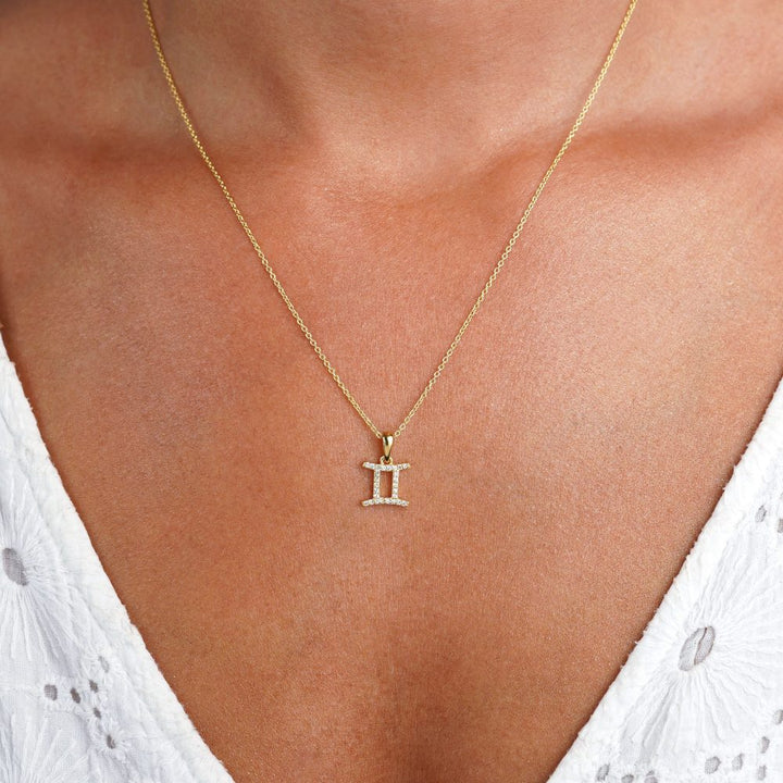 Gold necklace with Gemini (Twins) symbol filled with White Topaz crystals. Gemstone necklace with Gemini (Twins)  symbol that sparkles.