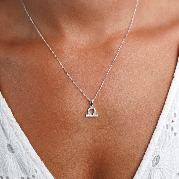 Silver necklace with Libra (Balance) symbol. Crystal necklace with Libra symbol filled with White Topaz gemstones.