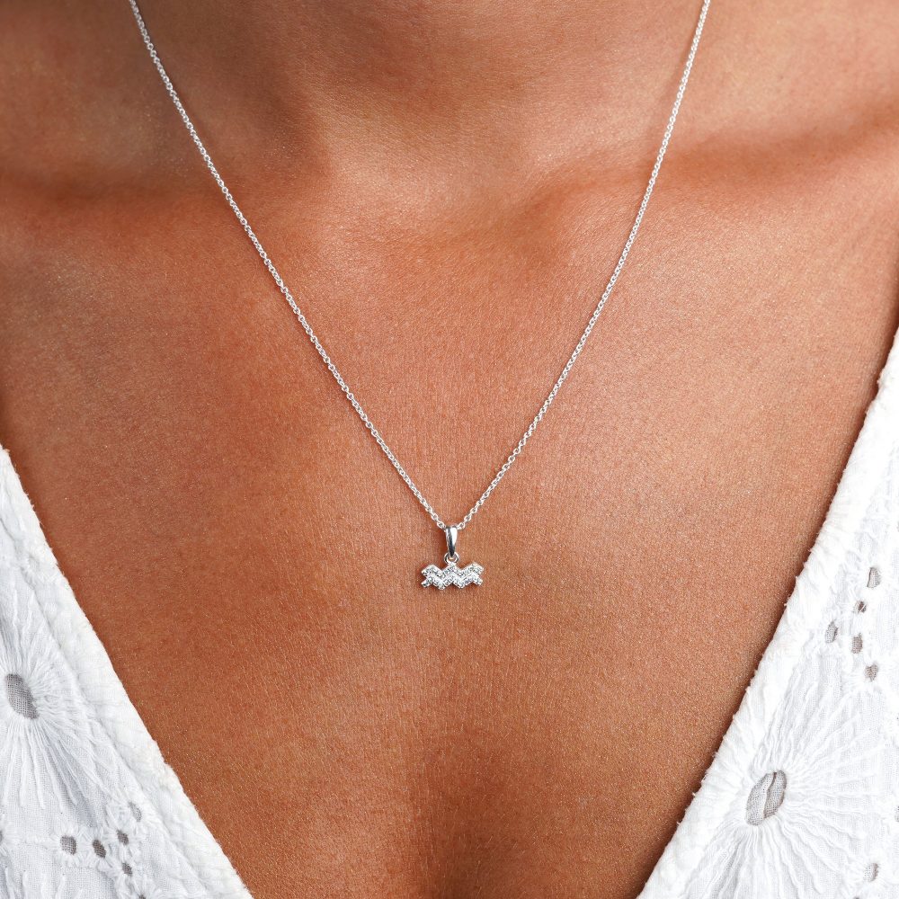 Silver necklace with Aquarius (Water Bearer) with White Topaz crystals. Zodiac necklace in silver with sparkly crystals.